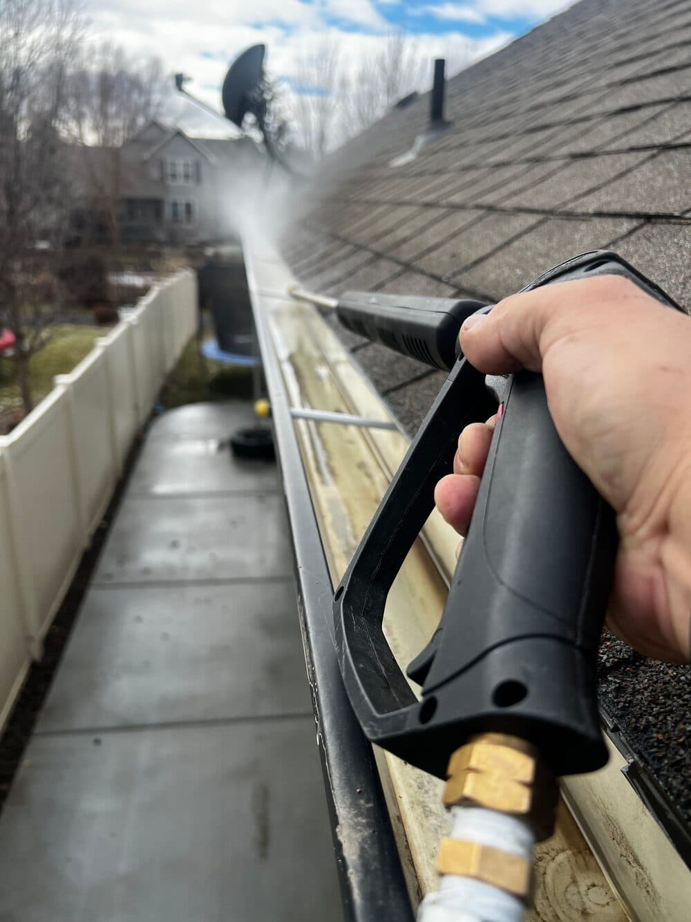 Rain gutter being cleaned